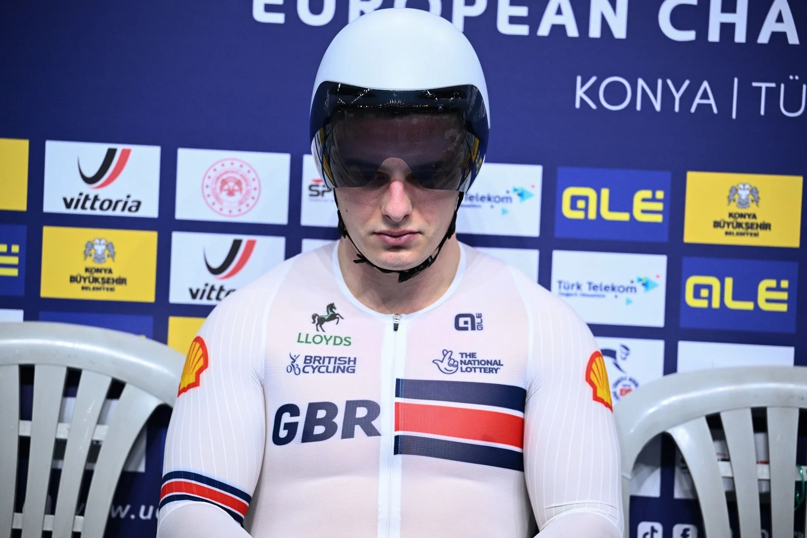 Matthew Richardson wearing a track helmet and Great Britain cycling kit