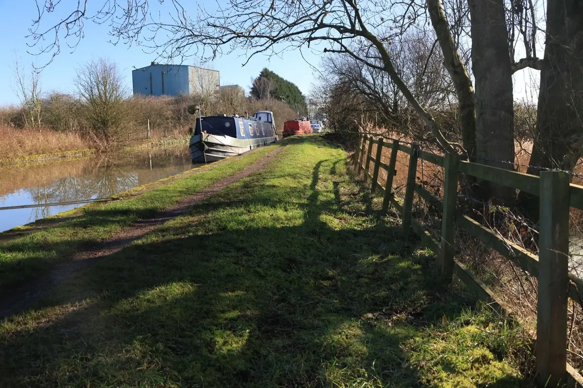 A narrowboat beside a UK canal towpath